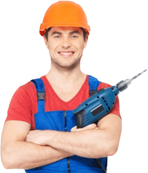 A construction worker holding a drill.