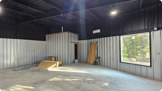 An empty room with metal walls and a window.